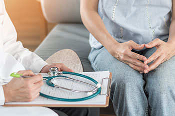 A waist-level shot of a doctor consulting a patient